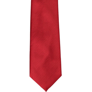 The front of a red ribbed necktie, laid flat