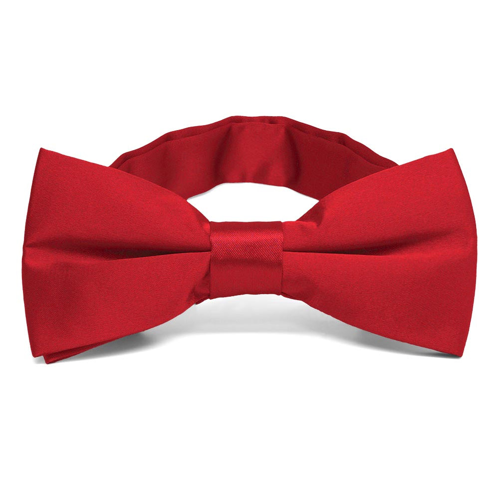A pre-tied shiny red bow tie with a collar