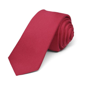 Solid red skinny tie, rolled to show the texture