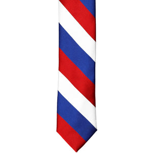 The front of a red, white and blue skinny striped tie, laid out flat