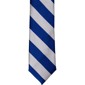 The front of a royal blue and silver striped tie, laid out flat