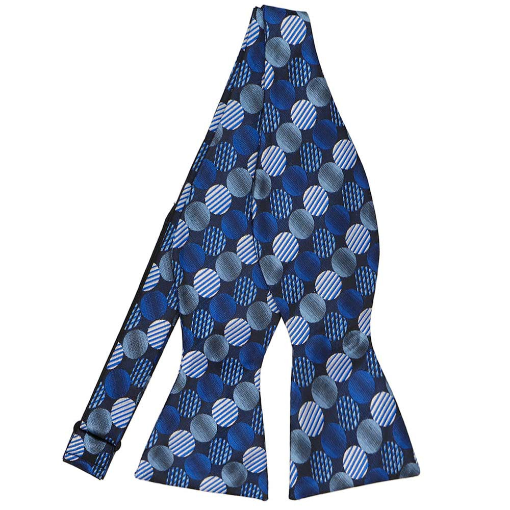 An untied self-tie bow tie in a royal blue, light blue and navy blue dotted pattern