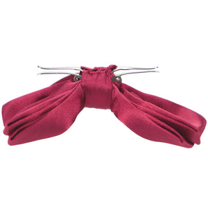 The side view of an opened ruby red clip-on bow tie