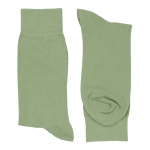 A folded pair of sage solid dress socks