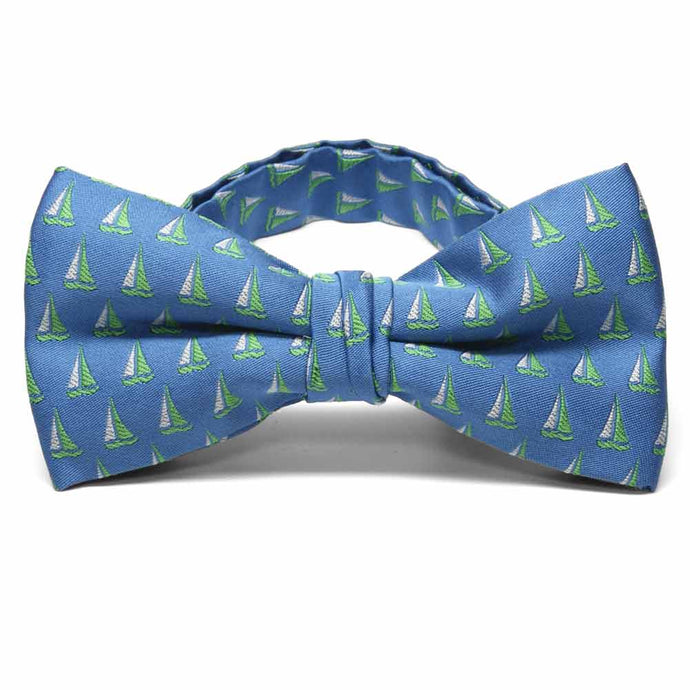 Green and white Sailboat theme bow tie on a blue background.