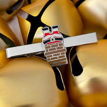 Load image into Gallery viewer, A Christmas-themed tie bar of Santa stuck in a chimney displayed with gold bells
