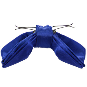 Side view of a sapphire blue clip-on bow tie, opened