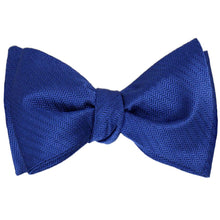 Load image into Gallery viewer, A sapphire blue herringbone self-tie bow tie, tied