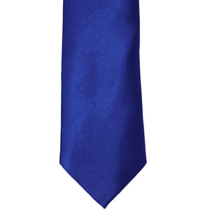 The front of a sapphire blue solid tie, laid out flat