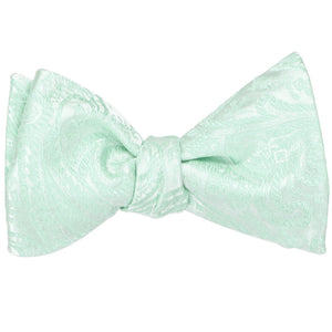 A seafoam paisley self-tie bow tie, tied