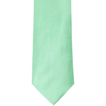 Load image into Gallery viewer, The front of a seafoam solid tie, laid out flat