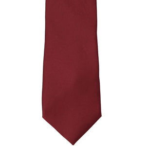 The front of a shiraz colored solid tie, laid out flat