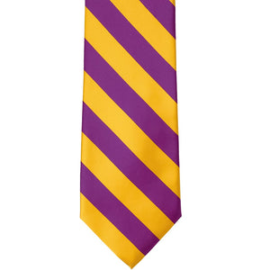 The front of a shocking violet and golden yellow striped tie, laid out flat