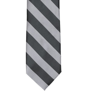 The front of a silver and dark gray striped tie, laid out flat