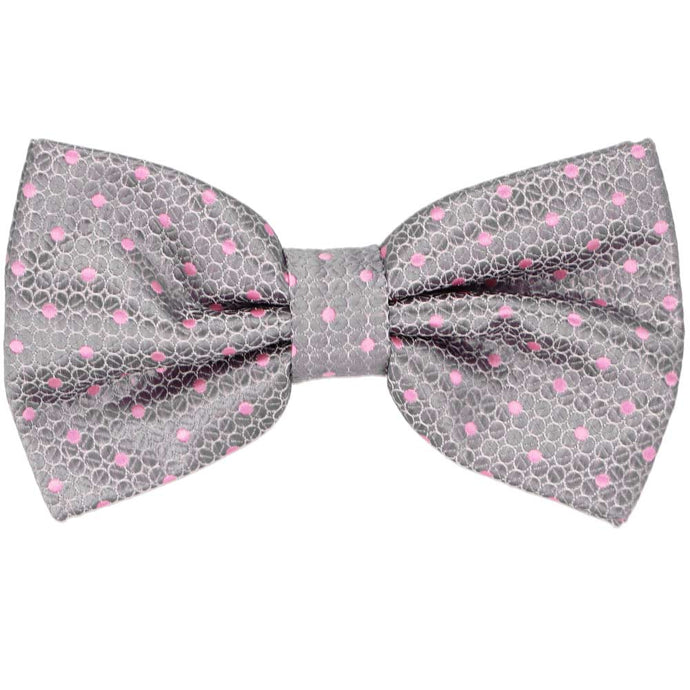 A light silver pre-tied bow tie with pink polka dots