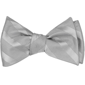 A tone-on-tone silver striped self-tie bow tie, tied