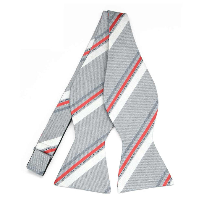 An untied silver self-tie bow tie with red and white stripes