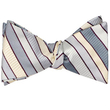 Load image into Gallery viewer, A silver and cream striped self-tie bow tie, tied