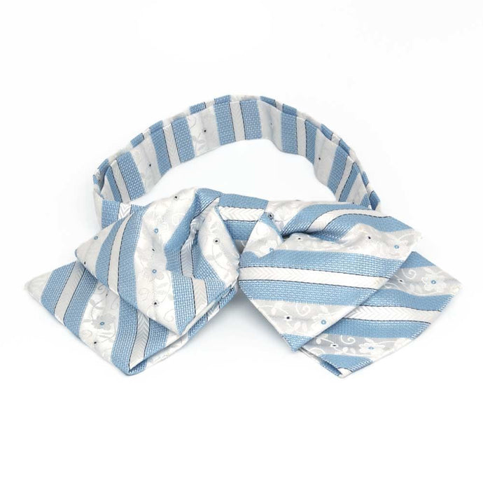 Front view of a blue and white floral stripe floppy bow tie