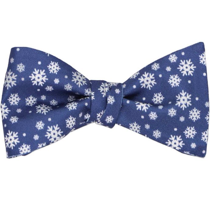A tied self-tie bow tie with a white and blue snowflake pattern