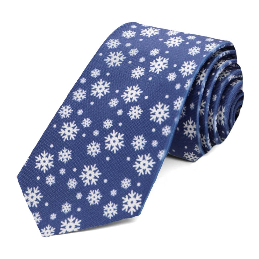A slim tie with in dark blue with scattered snowflakes