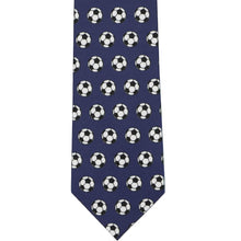 Load image into Gallery viewer, The front of a navy blue tie with an all over soccer ball pattern