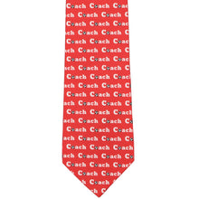 Load image into Gallery viewer, A red tie, flat, with an all over coach and soccer ball pattern