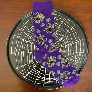 Spider and web socks displayed on top of a spider web platter