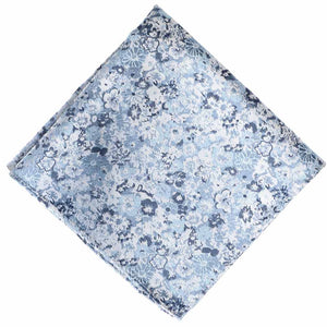 A folded light blue white and dark blue abstract floral pattern pocket square