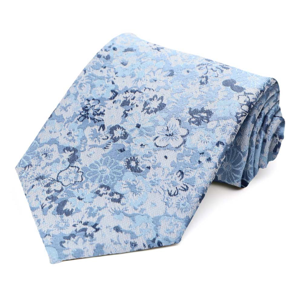 A floral extra long tie in shades of dusty blue, rolled to show off the pattern