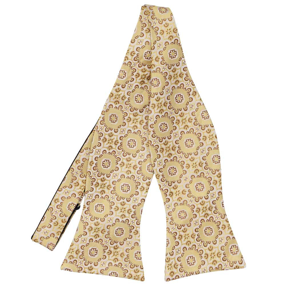Front flat view of an untied tan floral pattern self-tie bow tie