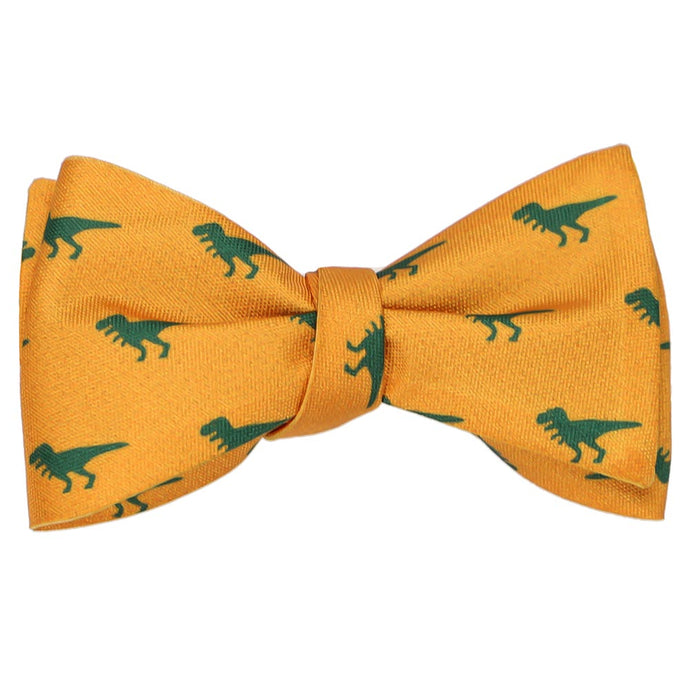A tied self-tie bow tie in a dark yellow and green t-rex dinosaur pattern  Edit alt text