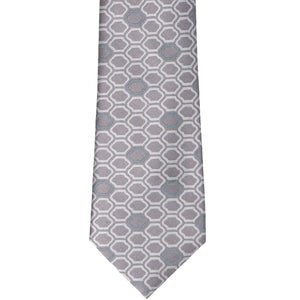 A taupe tie with an oval like geometric pattern
