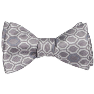 A tied self-tie bow tie in a taupe geometric pattern