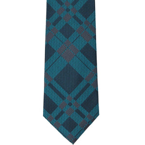 A dark teal and navy blue plaid necktie laid flat