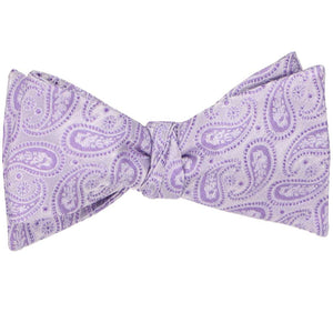 A tied self-tie bow tie in a light purple paisley pattern