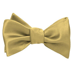 Tied light gold self-tie bow tie