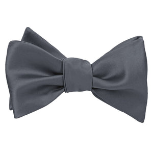 A pewter solid color self tie bow tie, tied