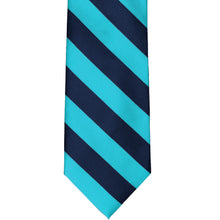 Load image into Gallery viewer, The front of a turquoise and navy blue striped tie, laid out flat