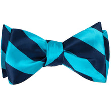 Load image into Gallery viewer, A striped turquoise and navy blue self-tie bow tie, tied