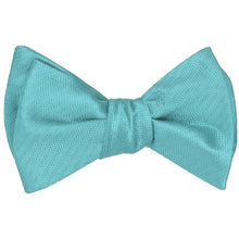 Load image into Gallery viewer, Turquoise self-tie bow tie, tied, in a herringbone pattern
