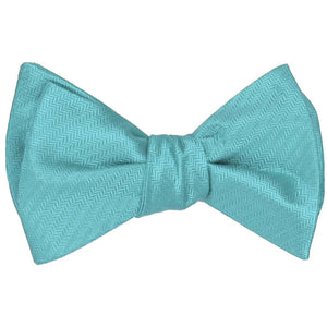 Turquoise self-tie bow tie, tied, in a herringbone pattern