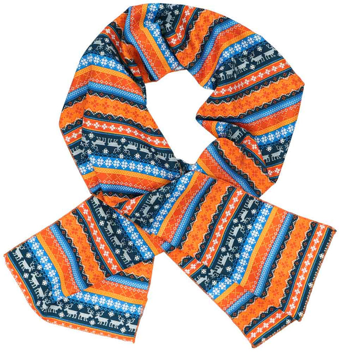 A women's scarf in a blue and orange ugly sweater pattern with reindeer and snowflakes, crossed over itself