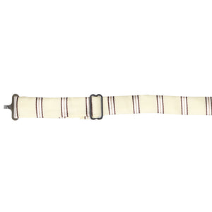 The band on a vanilla and brown striped floppy bow tie