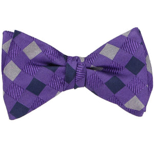 A violet checkered pattern self-tie bow tie, tied