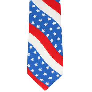 The front of a red, white and blue wavy star pattern necktie, laying flat