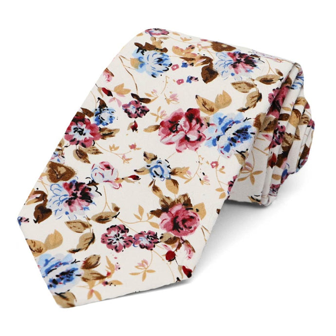A mauve, blue and tan floral pattern floral tie, rolled to show off the pattern