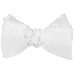 A tied white herringbone self-tie bow tie