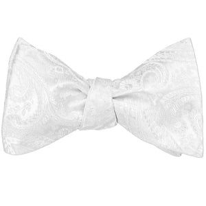 A tied self-tie bow tie in a white tone on tone pattern