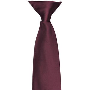 The knot and front of a wine colored clip-on tie